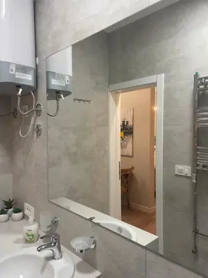 a bathroom with a sink and a mirror at Sunrise Suite in Kotor