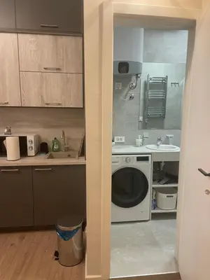 a kitchen with a washing machine and a sink at Sunrise Suite in Kotor
