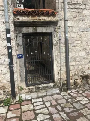 a window with a gate on the side of a building at Sunrise Suite in Kotor