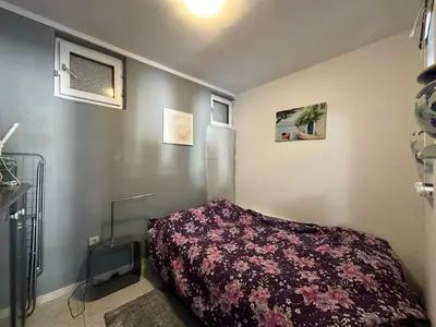 a bedroom with a bed with a purple blanket at Apartman Nenezic in Budva