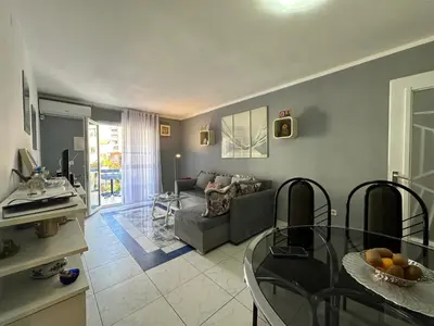 a living room with a couch and a glass table at Apartman Nenezic in Budva
