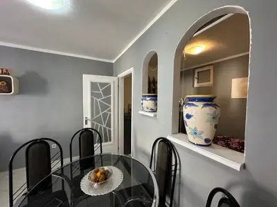 a dining room with a glass table and a vase at Apartman Nenezic in Budva