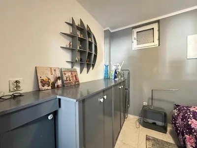 a room with a desk and a shelf and a bed at Apartman Nenezic in Budva