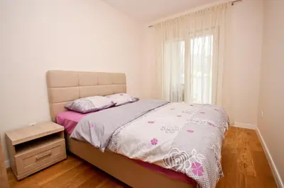 a bedroom with a bed and a dresser and a window at Sara in Bar