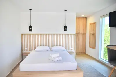 a bedroom with a bed with two towels on it at Tiny House with Hot Tub & View in Ulcinj