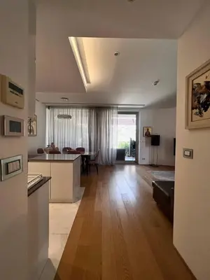 a living room with a kitchen and a dining room at Duklejski pogled in Budva