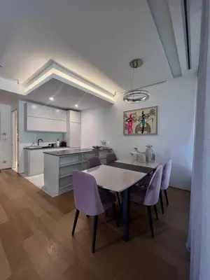 a kitchen and dining room with a table and purple chairs at Duklejski pogled in Budva