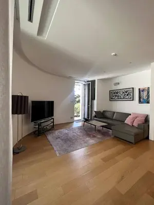 a living room with a couch and a flat screen tv at Duklejski pogled in Budva