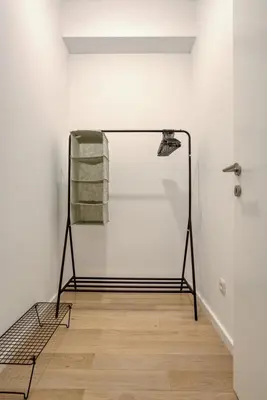 a room with a rack with towels on a wall at Studio apartment in Bar