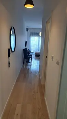 a hallway with a room with a table and a mirror at Studio apartment in Bar