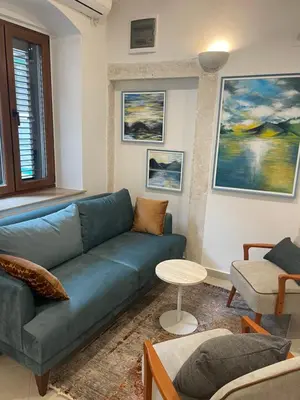 a living room with a blue couch and a table at Spirit of Kotor in Kotor