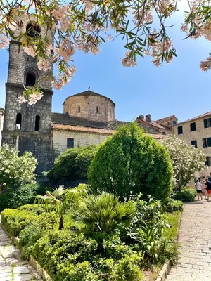 an old building with a clock tower in a garden at Spirit of Kotor in Kotor
