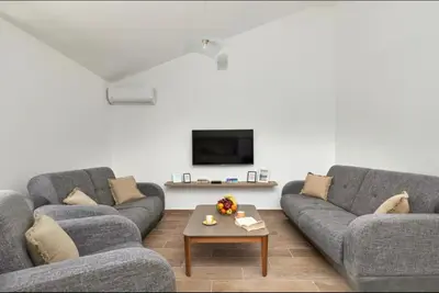a living room with two couches and a coffee table at Apartmani Nadja in Škaljari
