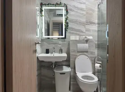 a bathroom with a toilet and a sink and a mirror at Apartmani Nadja in Škaljari
