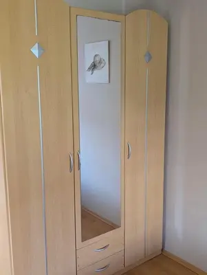 a wooden cabinet with a mirror in a room at Sunset Dreams Utjeha in Utjeha