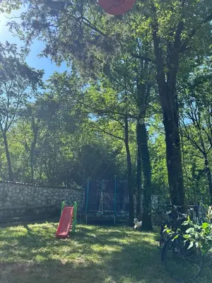 a park with a playground and a red slide at Etno House Šćepanov Hlad in Virpazar