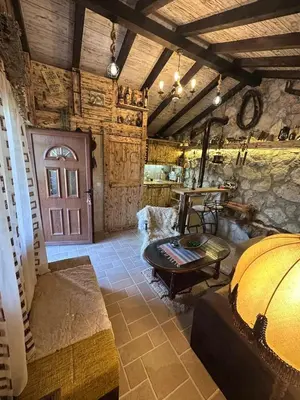 a living room with a large room with a door at Etno House Šćepanov Hlad in Virpazar