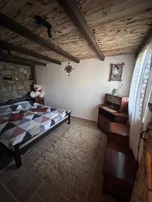 a bedroom with a bed and a sink in a room at Etno House Šćepanov Hlad in Virpazar