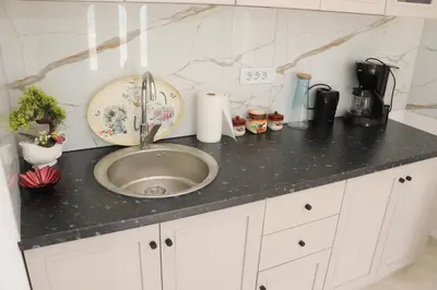 a kitchen counter with a sink in a kitchen at Panorama Hill Apartments Ulcinj in Ulcinj