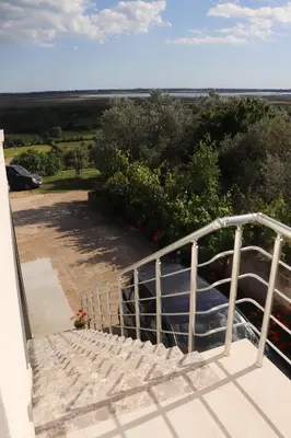 a view from the balcony of a house with a boat at Panorama Hill Apartments Ulcinj in Ulcinj