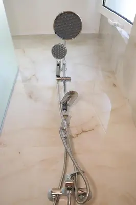 a barber chair sitting on the floor in a bathroom at Panorama Hill Apartments Ulcinj in Ulcinj