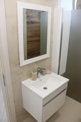 a bathroom with a white sink and a mirror at Panorama Hill Apartments Ulcinj in Ulcinj