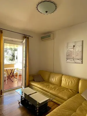 a living room with a couch and a table at Two Bedroom Apartment Budva in Budva