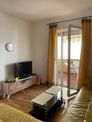 a living room with a flat screen tv and a couch at Two Bedroom Apartment Budva in Budva