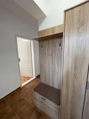a room with a wooden cabinet with a door at Two Bedroom Apartment Budva in Budva