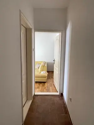 a view of a hallway with a couch in a room at Two Bedroom Apartment Budva in Budva