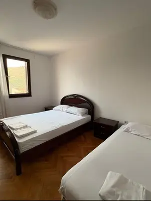 a bedroom with two beds and a window at Sea&Sun in Sutomore