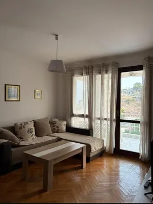 a living room with a couch and a coffee table at Sea&Sun in Sutomore