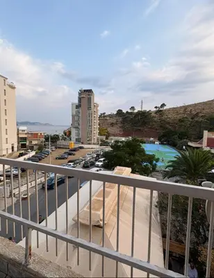a view from a balcony of a parking lot and a pool at Sea&Sun in Sutomore