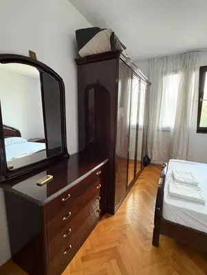 a bedroom with a dresser with a mirror and a bed at Sea&Sun in Sutomore