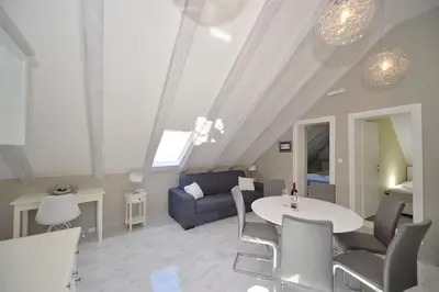 a living room with a couch and a table at Captain Double Suite in Kotor
