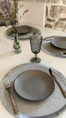 a table with plates and utensils on a table at Captain Double Suite in Kotor