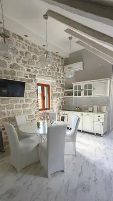 a kitchen with a white table and white chairs at Captain Double Suite in Kotor