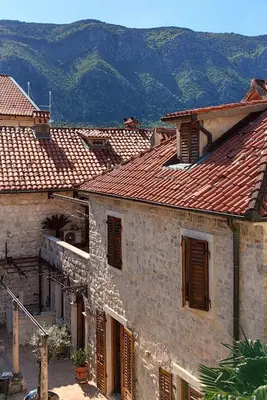 a group of buildings with mountains in the background at Captain Double Suite in Kotor