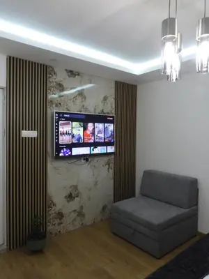 a living room with a couch and a flat screen tv at Boskovic Apartments in Podgorica