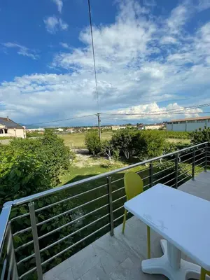 a table and a chair on a balcony with a view at Boskovic Apartments in Podgorica