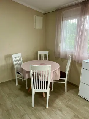 a dining room table with three chairs and a window at Casa di Lipa in Bar