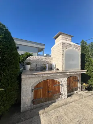 a stone oven with two doors on a house at Casa di Lipa in Bar