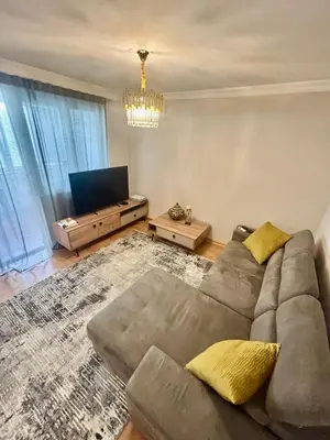 a living room with a couch and a television at Gold Lux in Podgorica