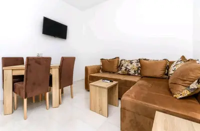 a living room with a couch and a table at Guest House Ana in Petrovac na Moru