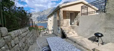 a bench sitting on the side of a building at Apartment Vujosevic D&D in Kotor