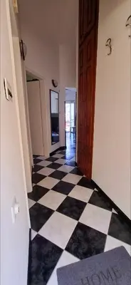 a hallway with a black and white checkered floor at Apartment Vujosevic D&D in Kotor