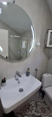 a bathroom with a white sink and a mirror at Apartment Vujosevic D&D in Kotor
