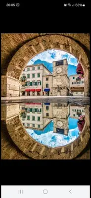 a picture of a building with a clock on it at Apartment Vujosevic D&D in Kotor