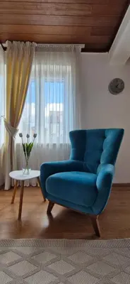 a blue couch in a living room with a window at Apartment 086 in Cetinje