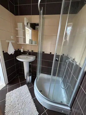 a bathroom with a shower and a sink at Apartment 086 in Cetinje
